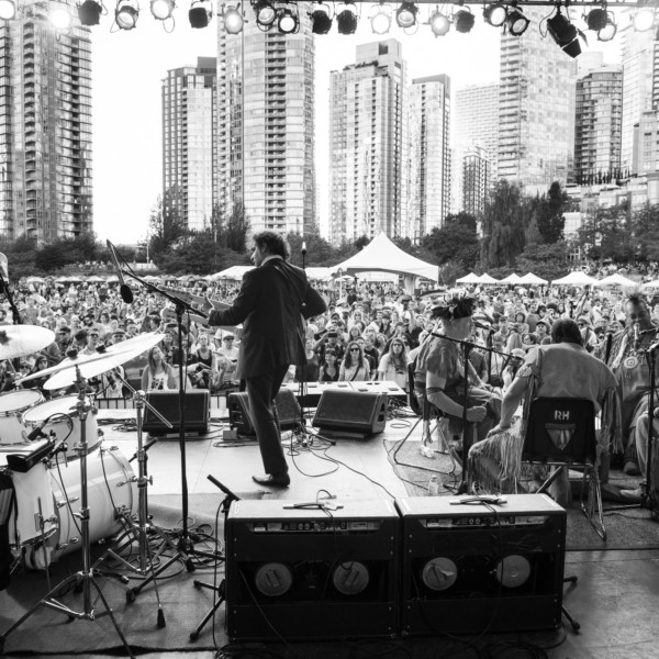 Yonatan Gat and the Eastern Medicine Singers perform onstage in front of a crowd.