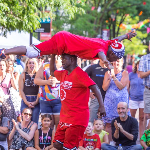 Tic & Tac performing, with one banaced on top of the other's head.