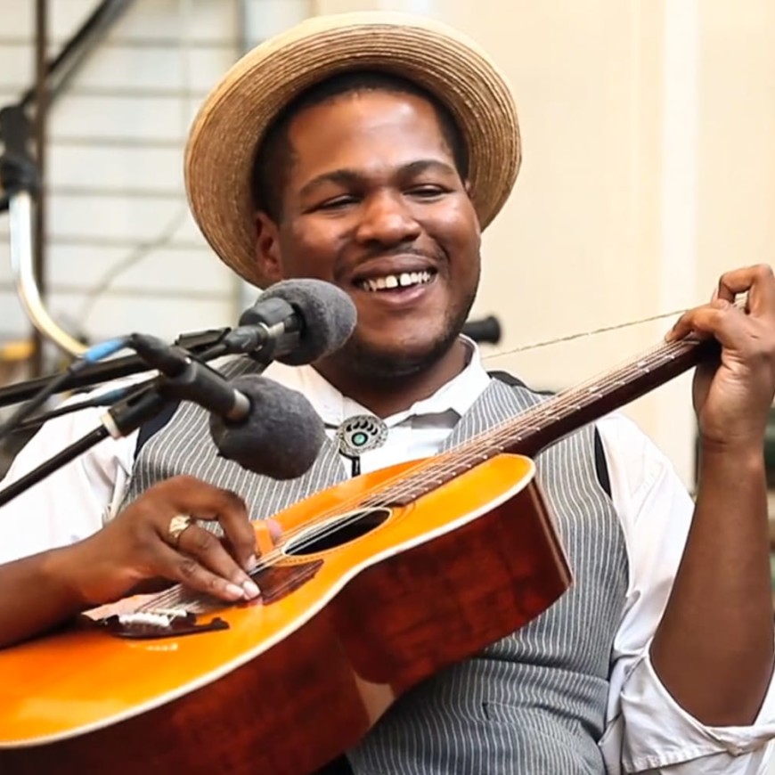 Jerron "blind boy" paxton, plays the guitar and wears a straw hat.